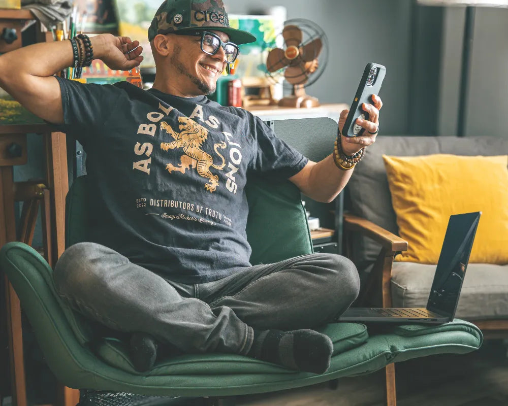 Content creator Joel Santana relaxing comfortably in his home office on an Amseatec signature criss cross chair during a product review.